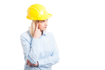 Portrait of woman engineer making thinking gesture