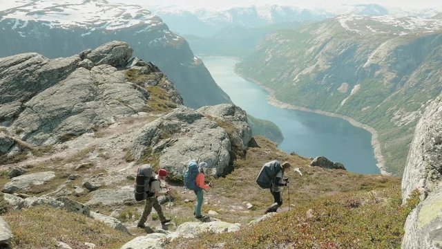 Backpackers go to the Trolltunga in Norway