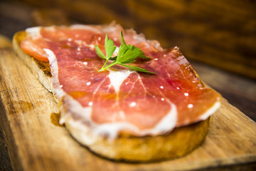 Bread toast with iberian cured pork ham and olive oil
