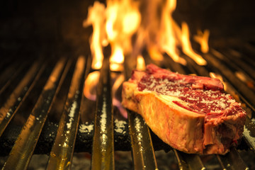 Cooking t-bone grilled steak in the barbecue