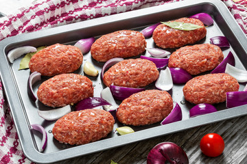 fresh ground raw meat cutlets with red onion