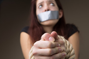 Woman gagged and tied hands - obrazy, fototapety, plakaty