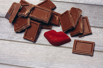 broken chocolate segments and red lips