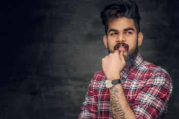 Attractive bearded Indian man in plaid fleece shirt.