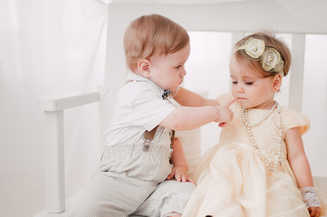 two babies wedding - boy and girl dressed as bride and groom
