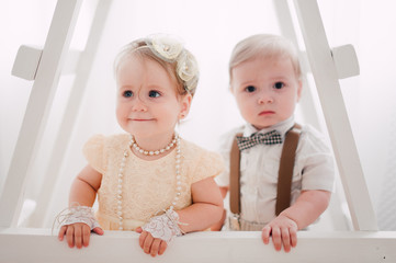 two babies wedding - boy and girl dressed as bride and groom
