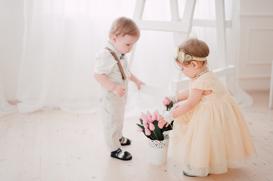 two babies wedding - boy and girl dressed as bride and groom