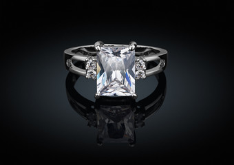 jewelry ring with big square clean diamond on black background w