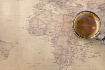 Black coffee  top view on world map