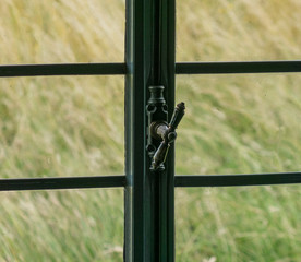 The window with latch of an old farmhouse inside