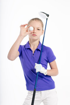 Pretty girl golfer posing with golf club on white backgroud in studio