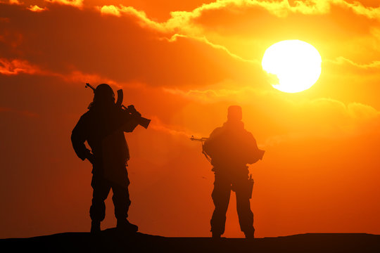 Two silhouette of a soldier on a beautiful background