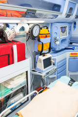 Inside the ambulance, view from the sanitary compartment. Different medical equipment and a baralla. Selective focus, high key.