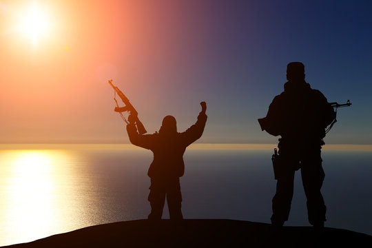 Two silhouette of a soldier on a beautiful background