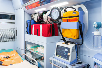 Inside the ambulance, view from the sanitary compartment. Different medical equipment and a...