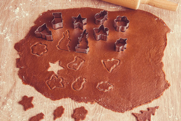 Christmas gingerbread cooking and decoration on the wooden table in the kitchen. Homemade pastries.