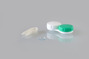 Container for contact lenses, tweezers, glass table