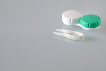 Container for contact lenses, tweezers, glass table