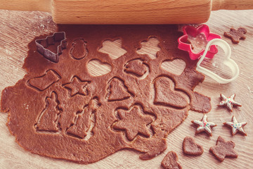 Christmas gingerbread cooking and decoration on the wooden table in the kitchen. Homemade pastries.