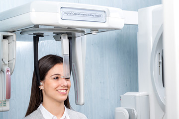 Girl taking digital panoramic x-ray in clinic.