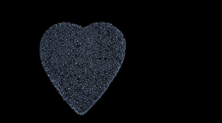 black caviar heart isolated on black with space for text
