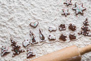 Christmas gingerbread cooking and decoration on the wooden table in the kitchen. Homemade pastries.