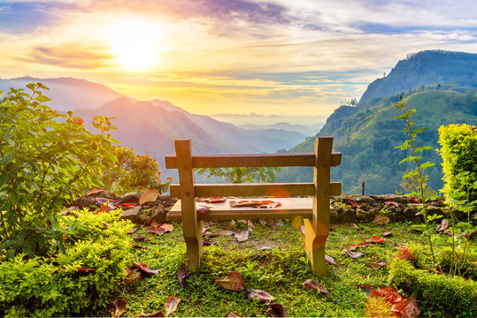 A bench with a view of the beautiful mountain valley at dawn. El