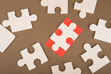 Business Teamwork Concept - Jigsaw Puzzle Pieces on brown background