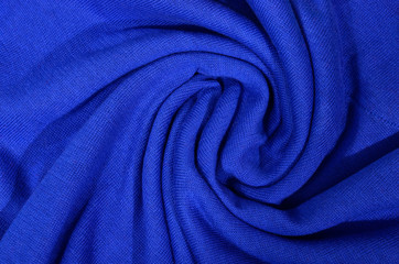 Dark blue folded wool fabric as background.