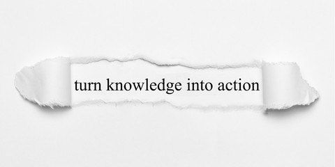 turn knowledge into action on white torn paper