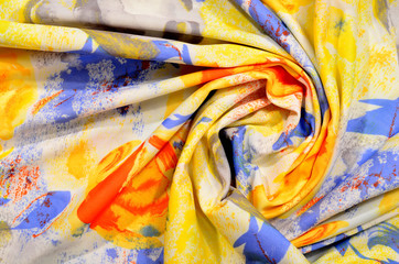 Floral pattern on colorful crumpled fabric.