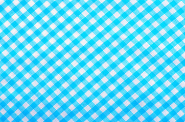Classic linen blue and white checked tablecloth on fabric.