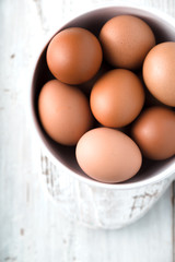 Chicken eggs  in the ceramic bowl  top view
