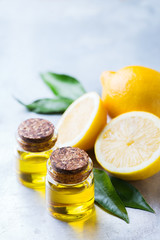 Organic essential lemon oil with green leaves and fruit