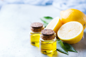 Organic essential lemon oil with green leaves and fruit