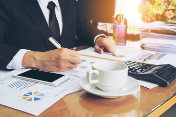 Businessman working check business report. Selective focus and soft flare filter.