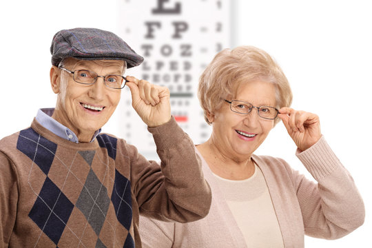 Seniors smiling in front of an eye chart