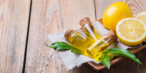 Organic essential lemon oil with green leaves and fruit © aamulya
