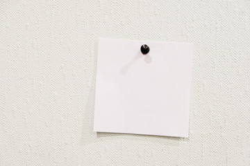 piece of paper attached to the wall