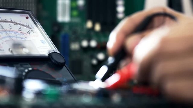 Dolly shot of a laboratory technician working with Multimeter
