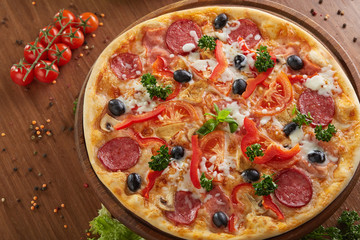 Tasty hot pizza with salami and pepper