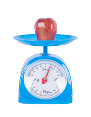 apple on kitchen scale isolated on white background