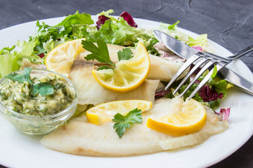 steamed tilapia fish with salad and tartar sauce with appliances