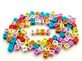 Fototapeta premium Letters spelling 'Love' on a white background.