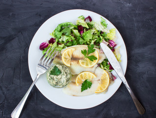 steamed tilapia fish with salad and tartar sauce with appliances