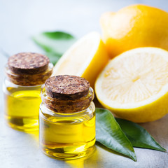 Organic essential lemon oil with green leaves and fruit