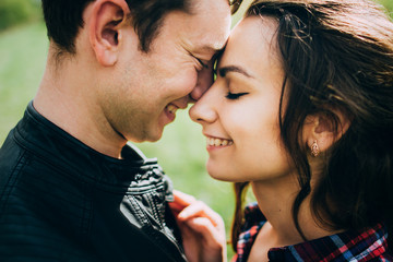 Portrait of happy couple in love embracing and looking at each o