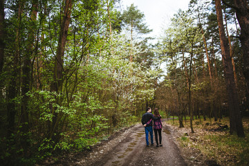 Obraz premium Happy young couple walking through the forest