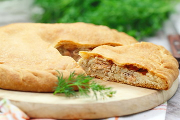 Pie with red fish and rice
