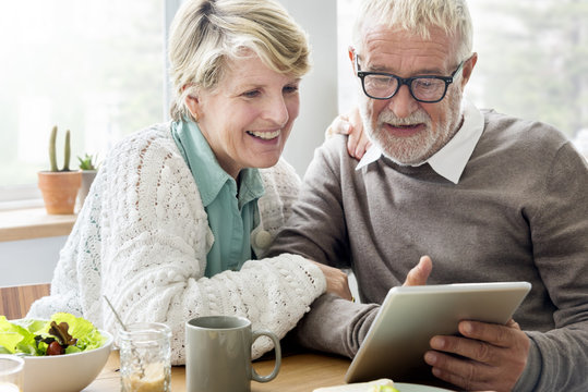 Senior Adult using Digital Device Tablet Concept